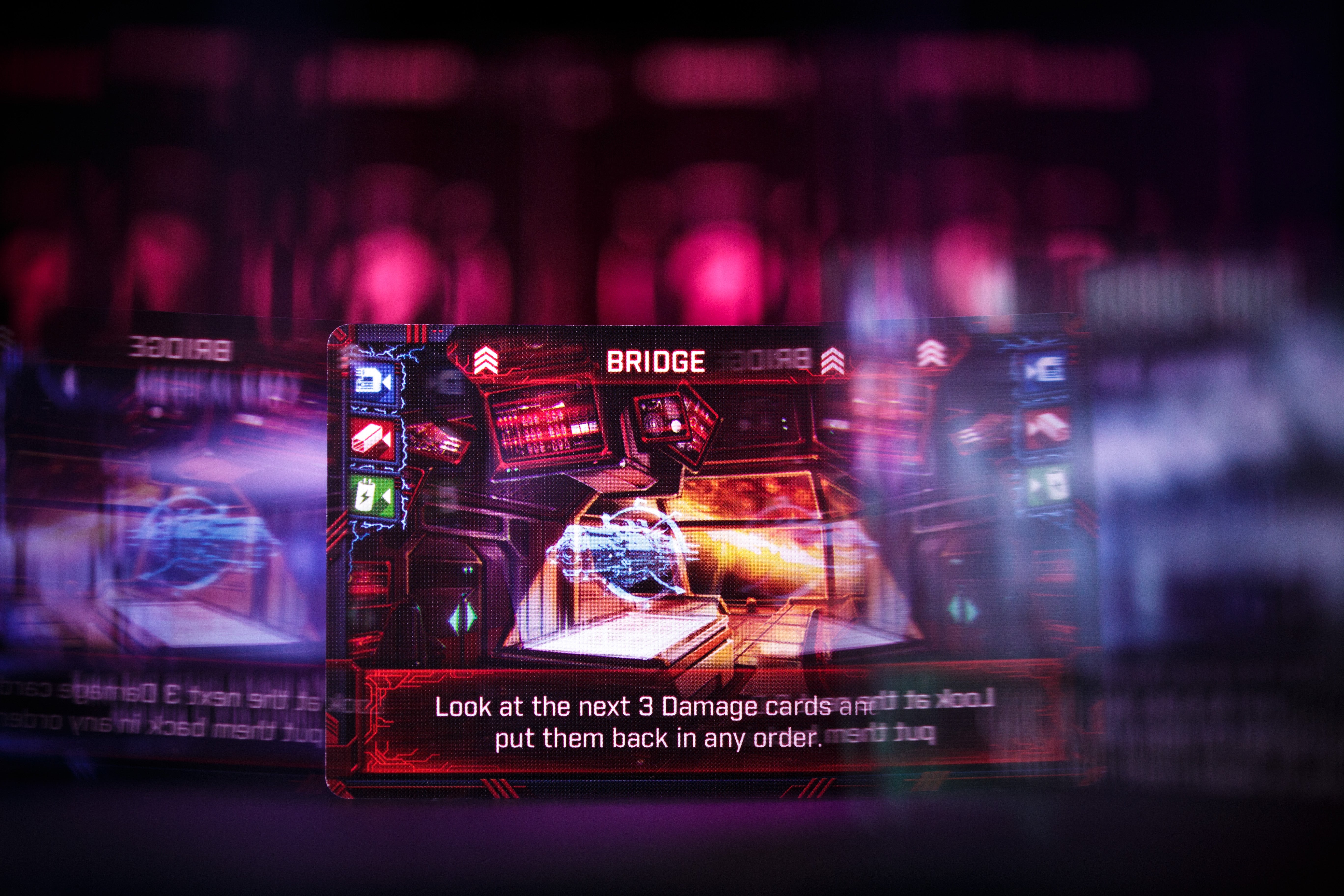 An artisan card from Explorers of Navoria showing a joint of meat being roasted over an open fire. Photographed with other artisan cards around it and some explorer tokens peeking out from either side.